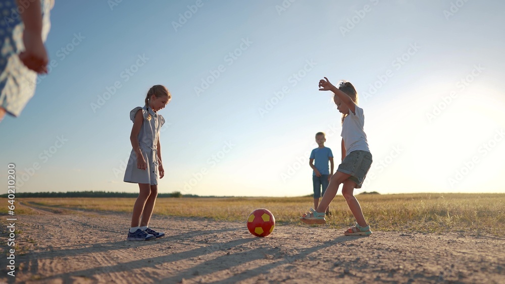 a group of small children playing football kicking the ball to each ...
