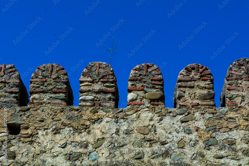 Low angle view of an medieval castle wall in Georgia. Fortification concept image.