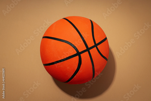 Basketball ball on beige background, concept of balls