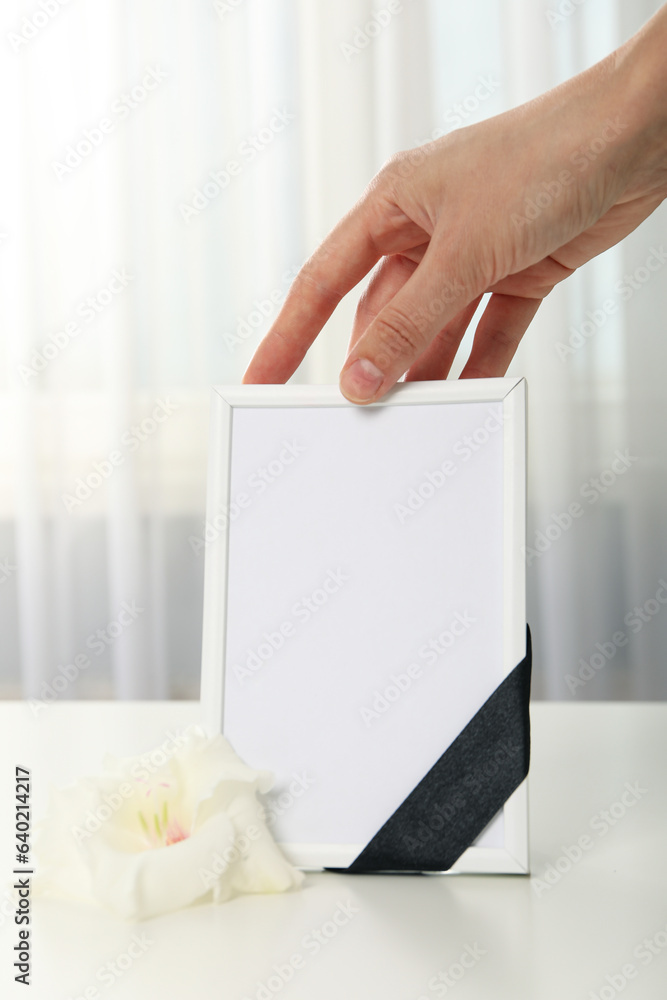 Photo frame, flower and female hand on light background Photo frame, flower and female hand on light background