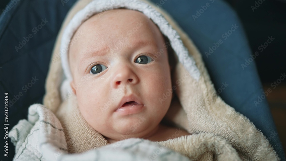 newborn baby swinging in a rocking chair. happy family kid dream concept. baby newborn close-up looking at the camera. lifestyle child infant wrapped in a towel swinging on a sun lounger rocking chair newborn baby swinging in a rocking chair. happy family kid dream concept. baby newborn close-up looking at the camera. lifestyle child infant wrapped in a towel swinging on a sun lounger rocking chair