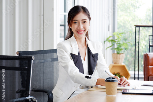 Young beautiful smiling happy business woman sitting at desk working.