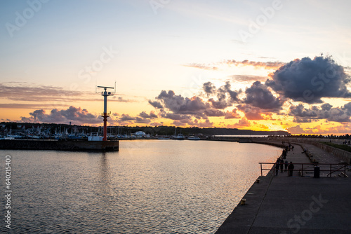 View of the harbor of the city of Wladyslawowo - Poland, in the evening, you can see the sunset, fishermen with fishing rods. © YuraFF