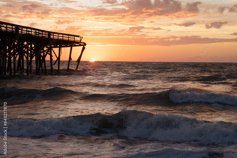Sunrise over the Pawley's Island fishing Pier one week after half the pier was destroyed by Hurricane Ian
