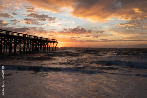 Sunrise over the Pawley s Island fishing Pier one week after half the pier was destroyed by Hurricane Ian