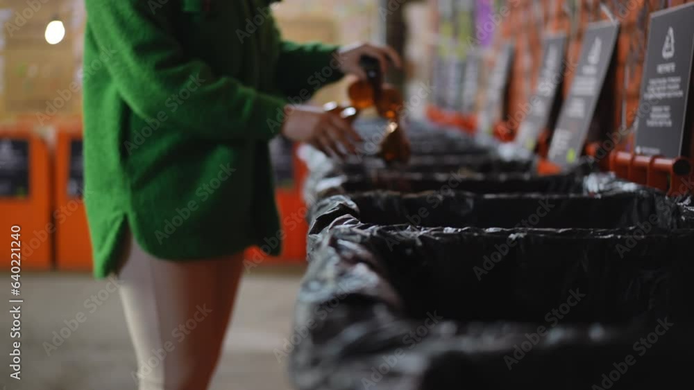Woman entering recycling station throwing away used plastic bottles leaving in slow motion. Side view Caucasian young lady sorting garbage for recycling indoors Woman entering recycling station throwing away used plastic bottles leaving in slow motion. Side view Caucasian young lady sorting garbage for recycling indoors