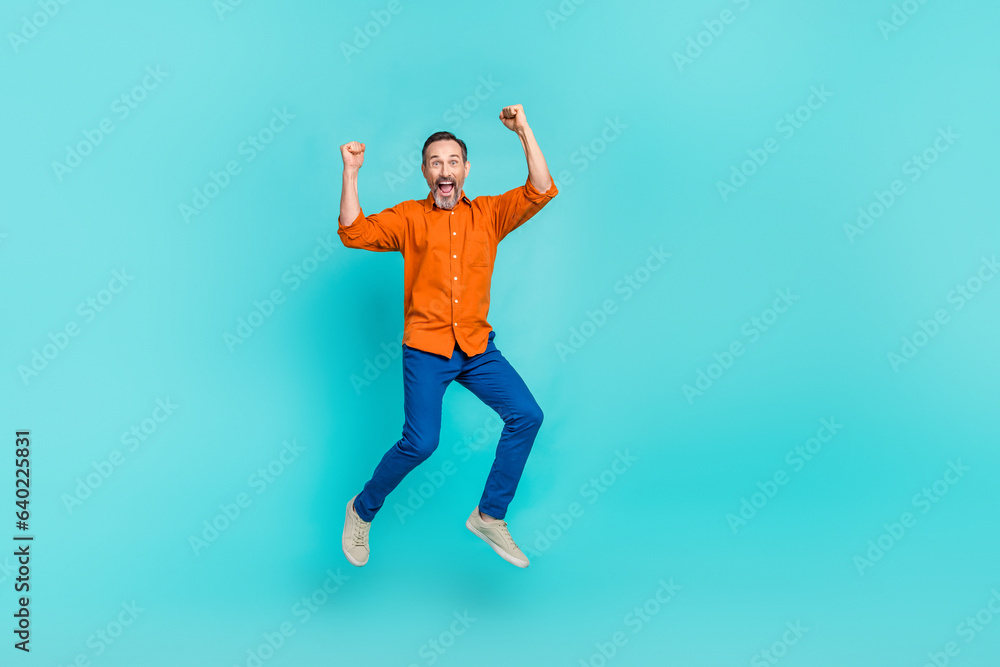 Full body length size photo of jumping overjoyed crazy businessman pensioner have fun fists up triumph isolated on cyan color background