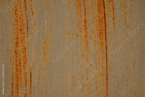 Orange rusty surface of old iron. Corroded metal background. Rusted white painted metal wall. Rusty metal background with streaks of rust. Rust stains. The metal surface rusted spots.