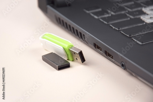 Fényképezés USB memory stick or flash drive on the keyboard of an open laptop
