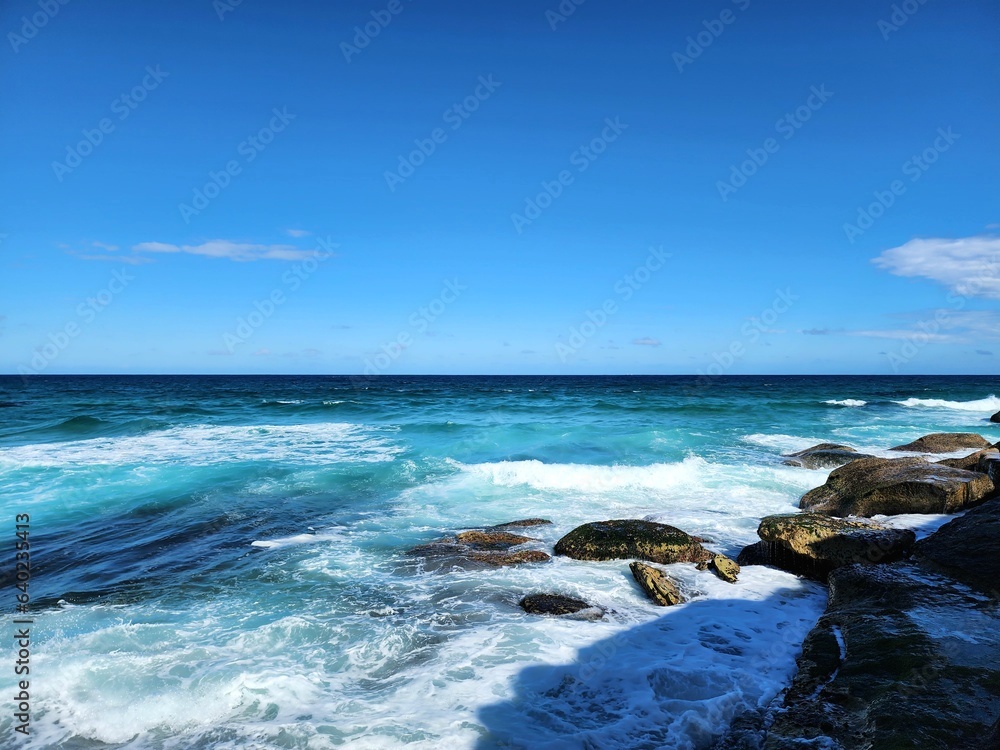 Natural seaside scene, view of the sky and sea horizon in a rocky seaside in Bondi, Australia Beach photographed from the top of the cliffs.