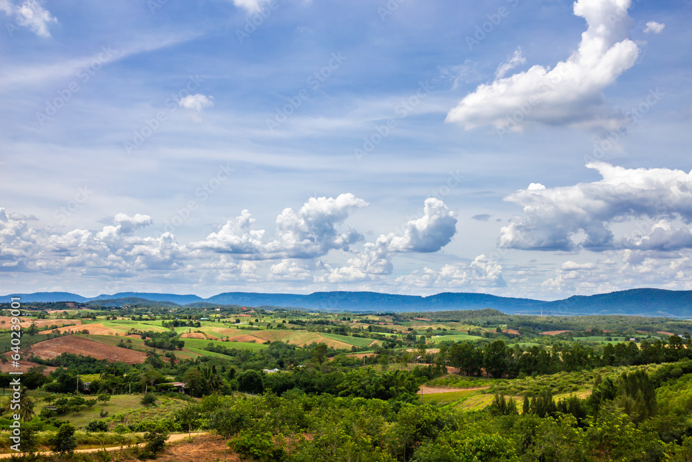 Landscape image of clouds, sky, mountains, trees and every grass in rural Thailand.