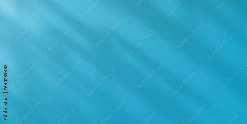 Light and shadow shine on the blue cement wall, revealing simple patterns. abstract background Light and shadow shine on the blue cement wall, revealing simple patterns. abstract background