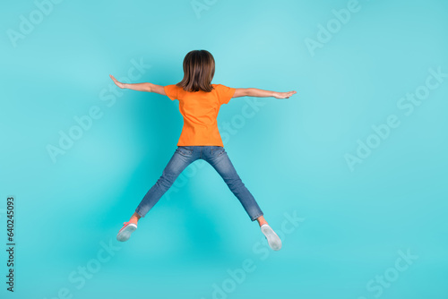 Back rear view photo of funky girl wear trendy clothes jump up fly air rejoice seasonal sale discount isolated on cyan color background