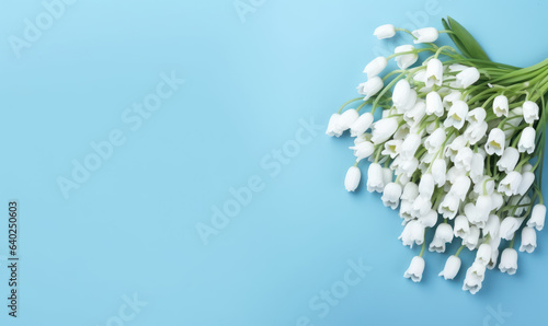 A snowdrop flowers bouquet on a pastel blue background with empty copyspace. Mother's Day concept. Created by generative AI © smth.design