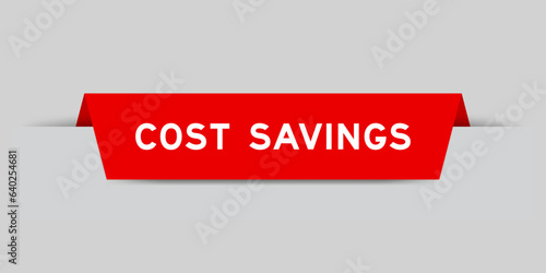 Red color inserted label with word cost savings on gray background
