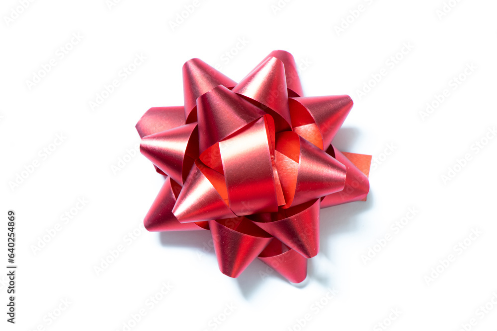 Ribbon bow banner in red color on white paper background Ribbon bow banner in red color on white paper background