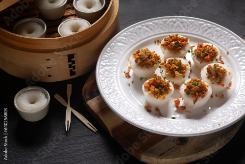 Asian food concept spot focus Chwee Kueh Strem savory rice cake on black background with copy space photo