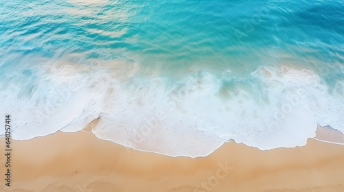Overhead photo of crashing waves on the shoreline beach. Tropical beach surf. Abstract aerial ocean view under sunshine