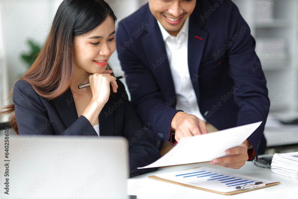 Boss and secretary working on documents together in office. Businessman and colleagues discussing in office collaboration. Boss and secretary working on documents together in office. Businessman and colleagues discussing in office collaboration.
