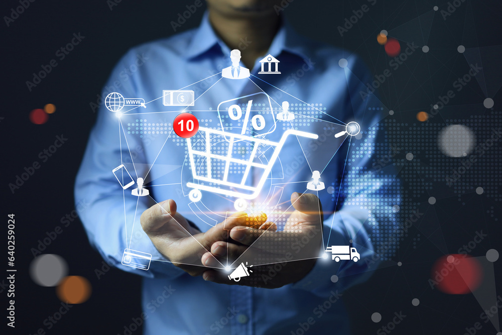 Seller or merchant is holding shopping cart to sales through online store marketplaces promotion discount percentages to attract customers to boost sales as a marketing strategy. - obrazy, fototapety, plakaty 