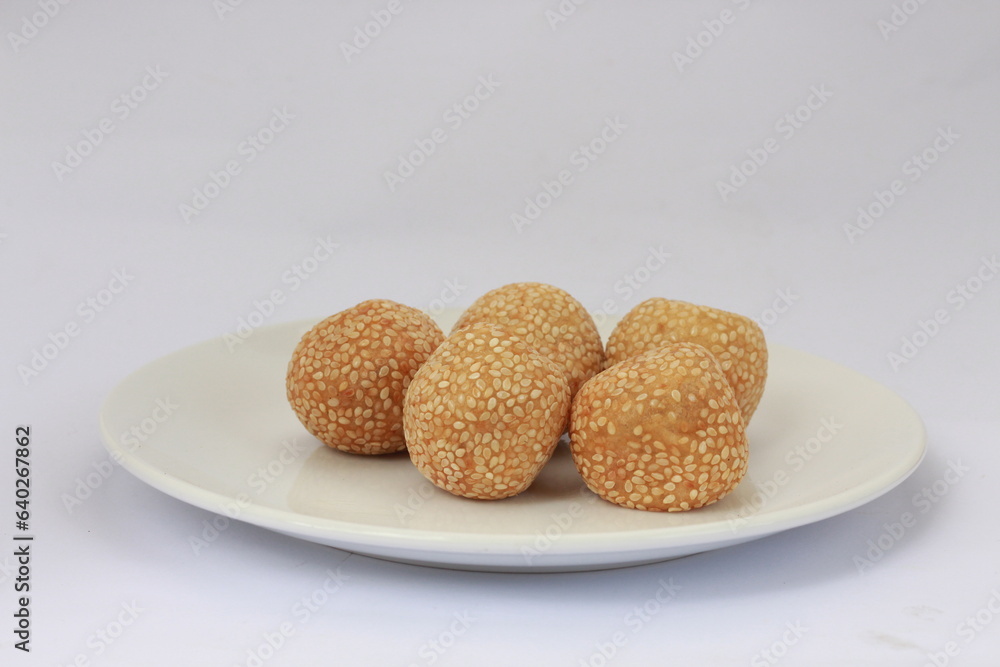 Onde-onde or jian dui is a type of cake that is popular in Indonesia. Onde-onde is a traditional food from Indonesia. Onde-onde served on a white plate