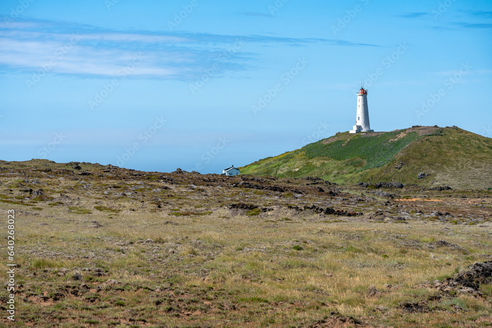 Reykjanes Lighthouse in Iceland, perched on a hill, overlooking the Atlantic Ocean
