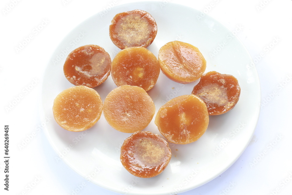 Javanese sugar or palm sugar served on a plate isolated on white background Javanese sugar or palm sugar served on a plate isolated on white background