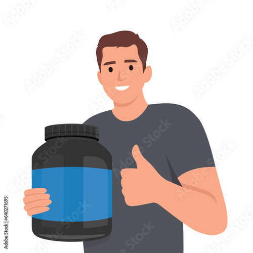 Smiling bodybuilder holding protein bottle recommend healthy lifestyle. Happy muscular guy with nutrition supplement in hands.