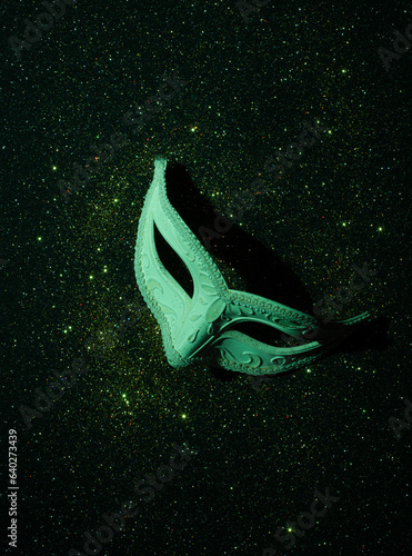 green masquerade eye mask isolated on black background