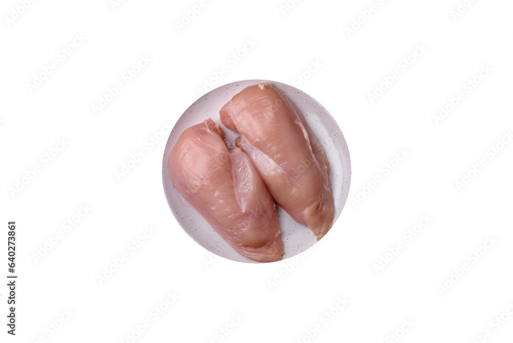 Fototapeta premium Pieces of raw chicken or turkey fillet with salt, spices and herbs