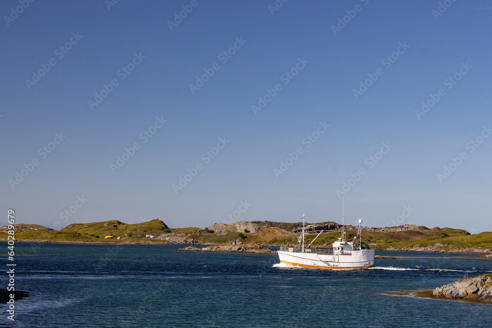 Fishing boat in to Fredvang harbour, Moskenes island in Lofoten, Nordland county, Norway