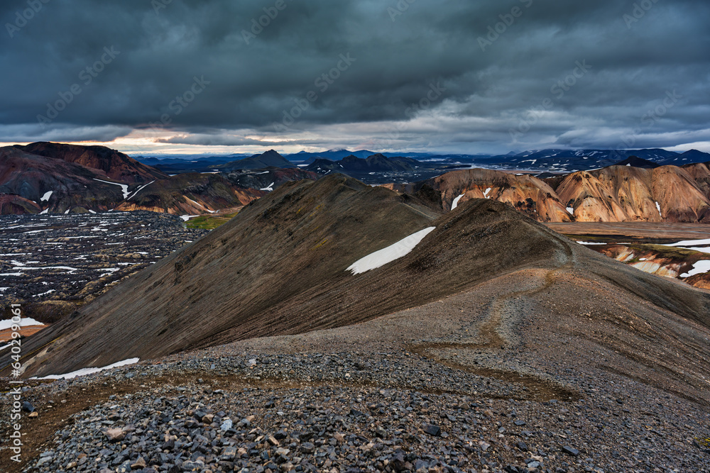 Landscape of volcanic mountain with moody sky on Blahnjukur trail among Icelandic highlands in summer
