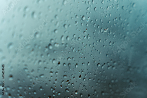 Rain water drops on the window in rainy season background