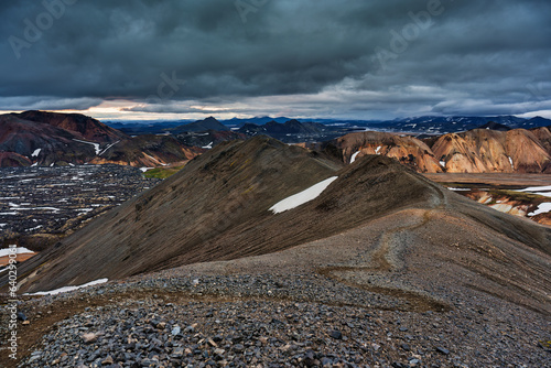 Landscape of volcanic mountain with moody sky on Blahnjukur trail among Icelandic highlands in summer photo