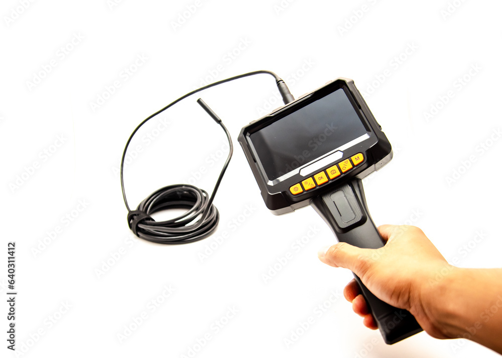 Asian man hand holding endoscope camera with semi-rigid cable borescope and dual lens isolated on white background, sewer snake, 5 inches IPS Screen medical industrial device Asian man hand holding endoscope camera with semi-rigid cable borescope and dual lens isolated on white background, sewer snake, 5 inches IPS Screen medical industrial device