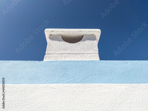 Cement chimney painted in soft mediterranean tones photo