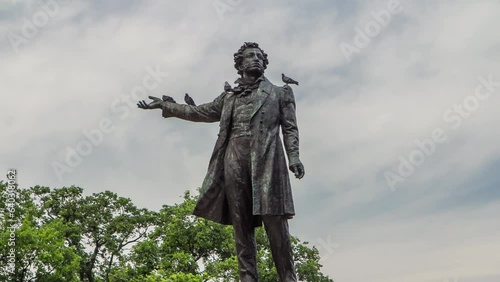 Alexander Pushkin Monument on Arts Square, Russian Museum (Mikhailovsky Palace) backdrop, captured in timelapse hyperlapse. St. Petersburg, Russia. Close up view