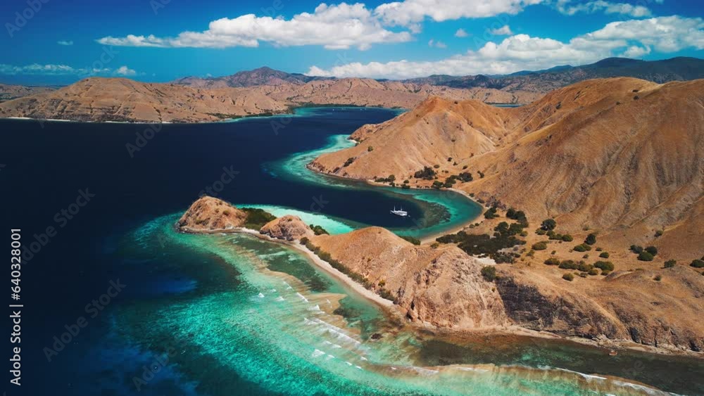 Komodo National Park during sunny calm day, Flores island, Indonesia. Aerial view of the tropical islands and lagoons with turquoise water Komodo National Park during sunny calm day, Flores island, Indonesia. Aerial view of the tropical islands and lagoons with turquoise water