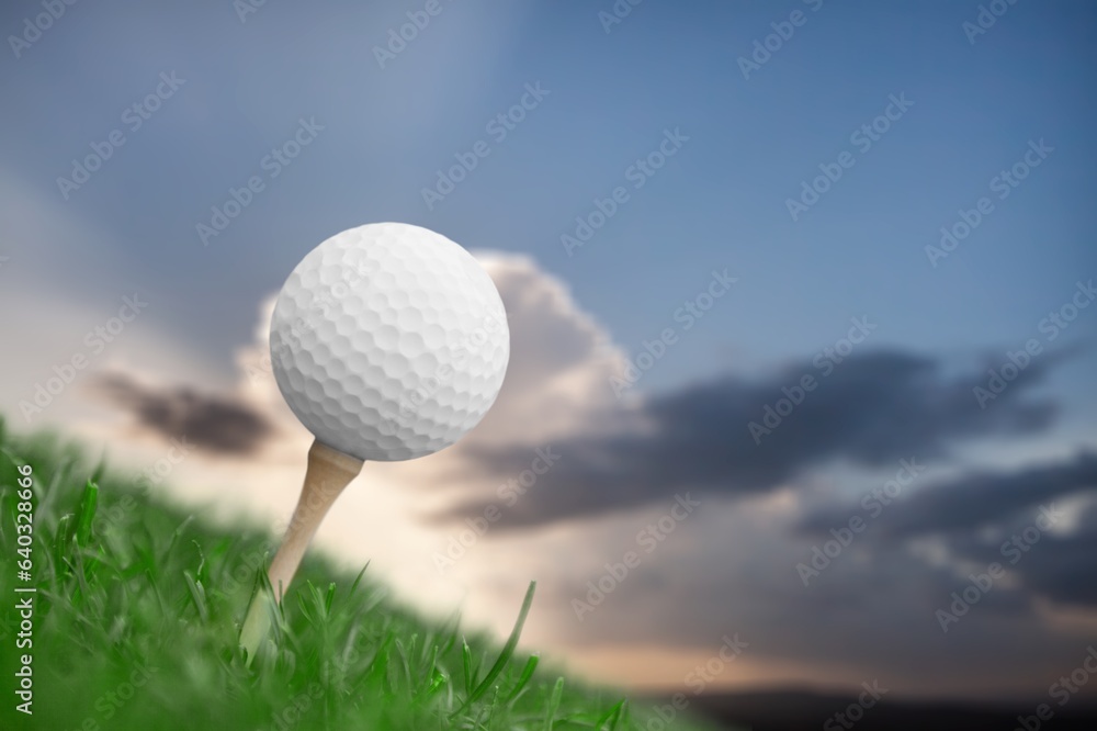 Golf white ball on tee on green grass Golf white ball on tee on green grass