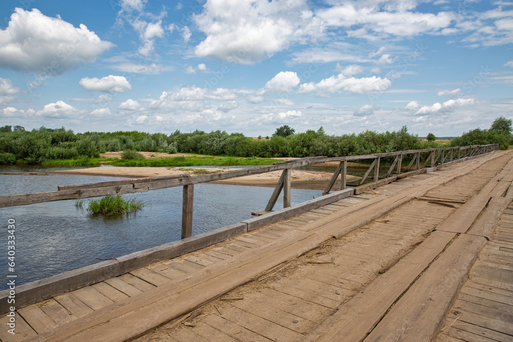 Old wooden bridge over Sluch river in Rivne region, Ukraine. Old wooden bridge over Sluch river in Rivne region, Ukraine.