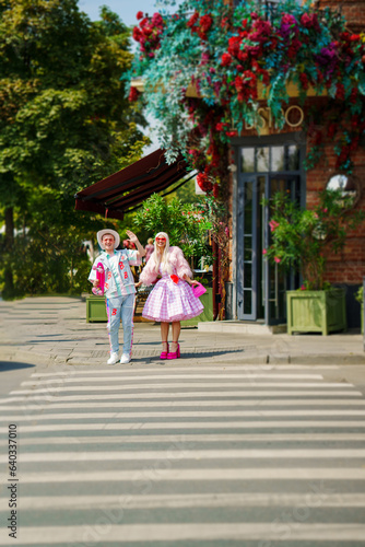 girl and boy walking around the city. The image of a popular doll for girls