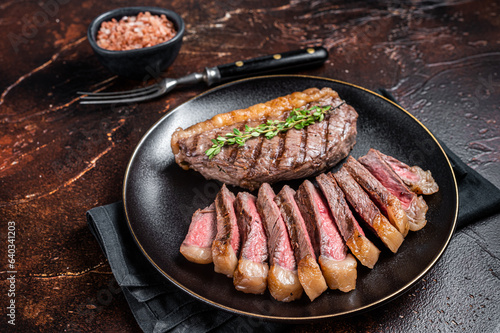 Fotografija Sliced grilled medium rare Top sirloin beef steak on a plate