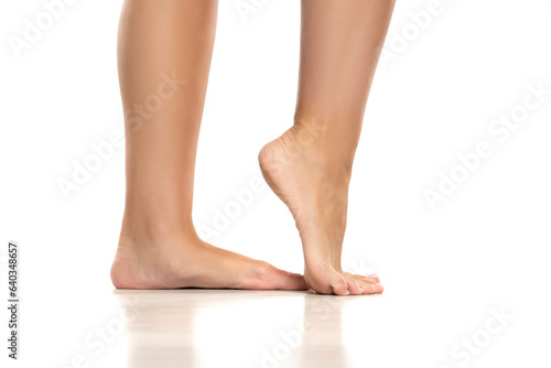 Side view of a beautifully cared female feet on a white background. © vladimirfloyd