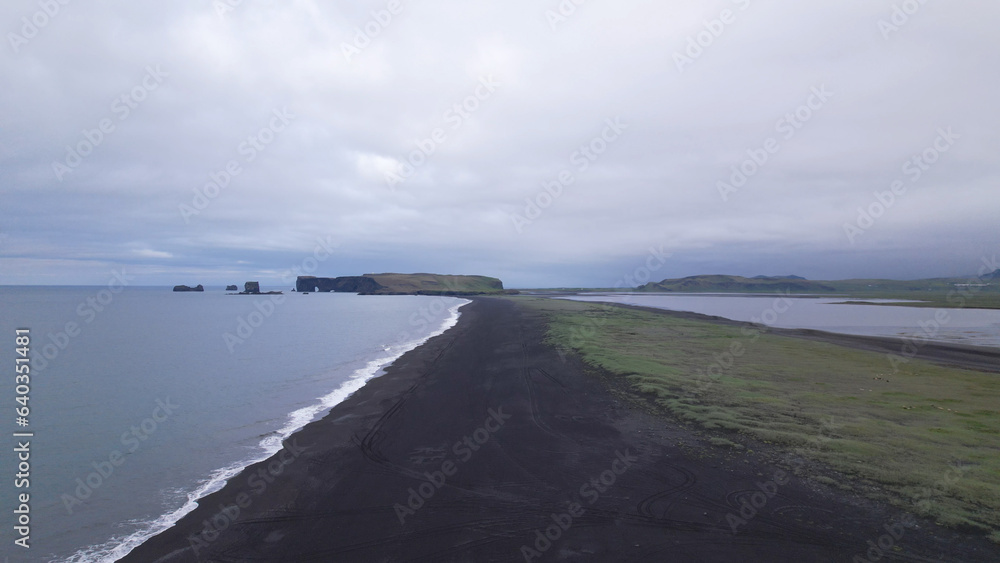 The Reynisfjara Black sand beach, Halsanefshellir cave, basalt columns and sea stacks at Vik i Myrdal in Iceland.