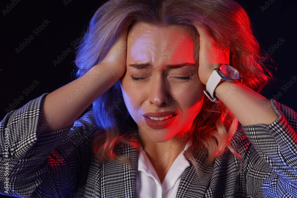 Young woman having panic attack on dark background Young woman having panic attack on dark background