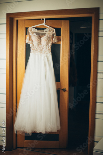 A sunlit room frames the A-line bridal gown, emanating radiant charm on the wedding day.