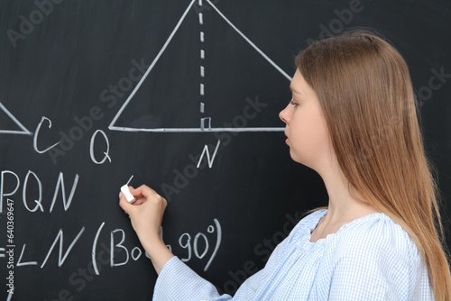 Young math teacher writing ...