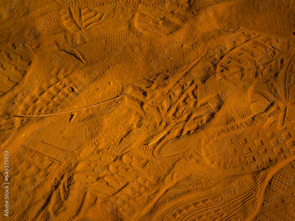 Fototapeta premium Footprints left on the red sand. Abstract Rustler canyon moher cliffs landscape. Provencal Colorado near Roussillon, Southern France.