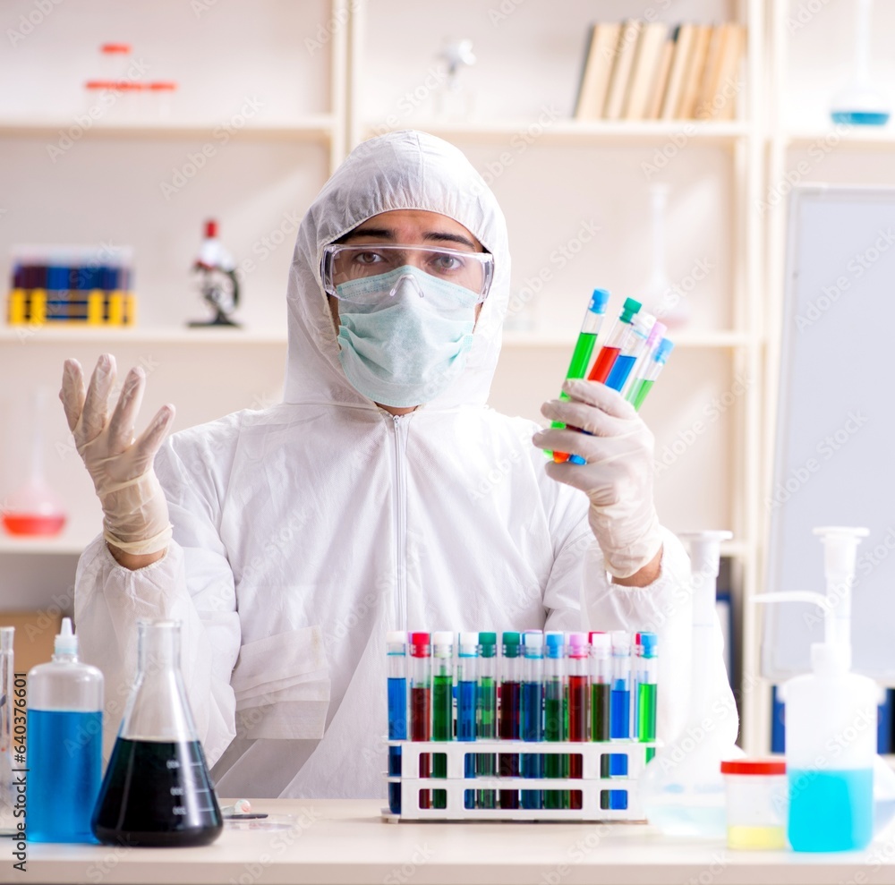 Young handsome chemist working in the lab Young handsome chemist working in the lab