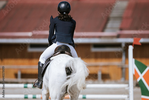 Photo of a woman riding a majestic white horse